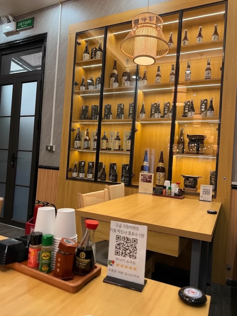 Tủ trưng bày rượu sake và bàn gỗ trong quán